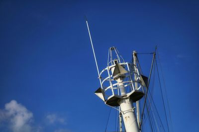 Low angle view of sailboat against blue sky