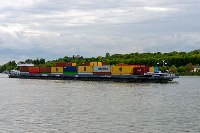 Boat in river against sky