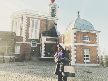 Full length of woman standing on city street