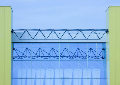 Low angle view of modern building against clear blue sky