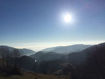 Scenic view of mountains against blue sky