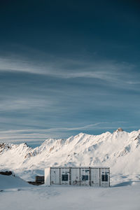 Scenic view of snow covered mountains against sky