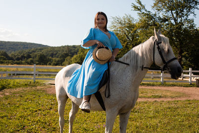 Full length of woman riding horse