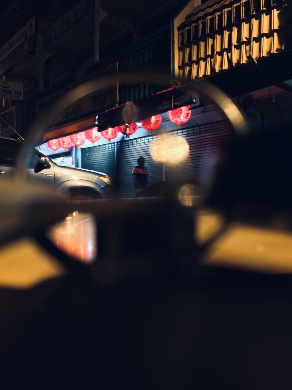 PEOPLE STANDING IN ILLUMINATED CITY