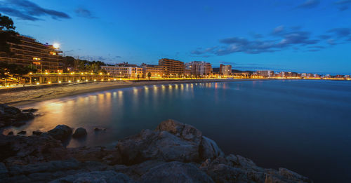 River passing through city at dusk