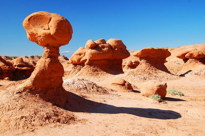 Scenic view of desert against clear blue sky