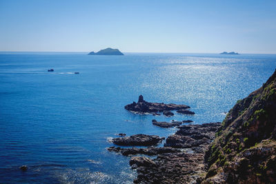 Scenic view of sea against clear blue sky