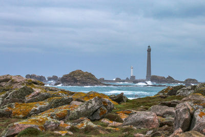 Rocks by sea against sky