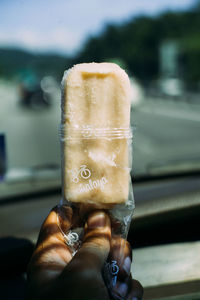 Close-up of hand holding ice cream