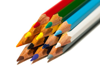 Close-up of colored pencils against white background