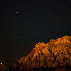 Scenic view of mountain against sky at night