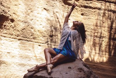 Woman sitting on wall