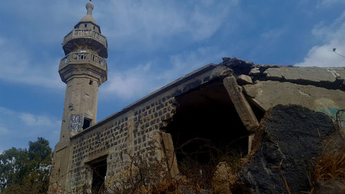 Low angle view of bell tower against sky