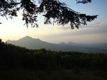Scenic view of silhouette mountains against sky at sunset