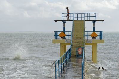 Lifeguard hut on beach against sky