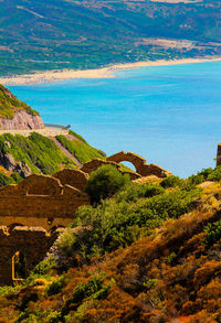 Scenic view of sea and mountains against sky