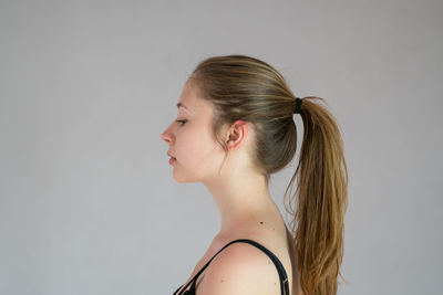 Portrait of a young woman against white background