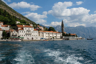 Residential town by sea against mountains