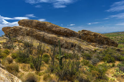 Scenic view of rocky mountains against blue sky