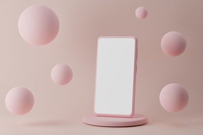 Modern smartphone on podium with flying bubbles on pink background, 3d render