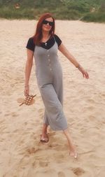 Full length portrait of woman on beach