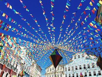 Low angle view of flags hanging against sky