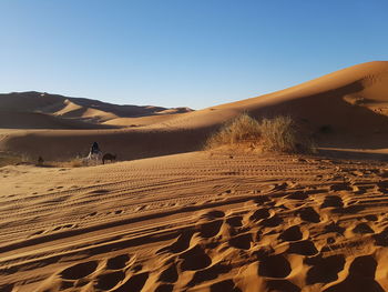 Scenic view of desert against clear sky