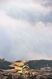 Scenic view of landscape against cloudy sky