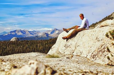 Woman standing on rocky mountain