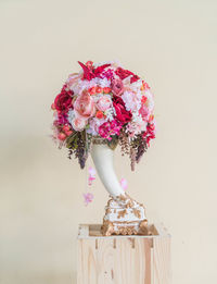 Close-up of pink flower vase against white background