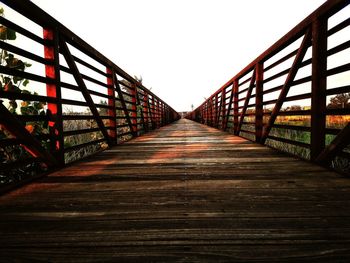 Footbridge against clear sky