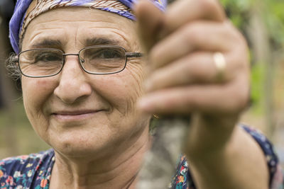 Close-up portrait of smiling woman wearing eyeglasses