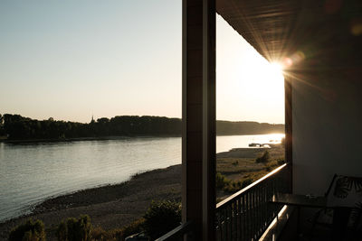 Scenic view of lake against clear sky during sunset