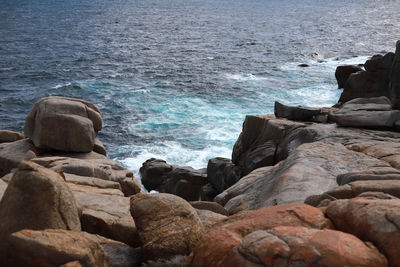 Rocks on beach against sky