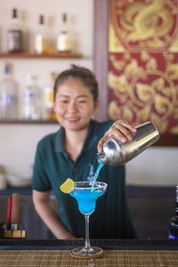 Female bartender preparing drink bar