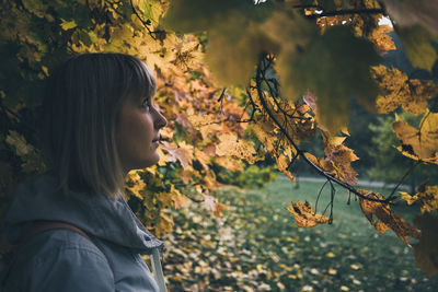 Woman standing in front of tree