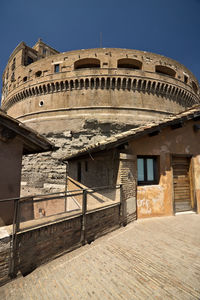 Low angle view of historical building against clear blue sky