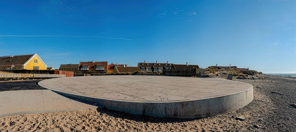 Scenic view of beach against sky on sunny day