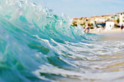 Close-up of wave in sea against sky