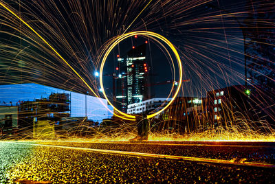 Light trails on bridge in city at night