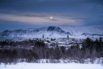 Scenic view of snow covered mountains against sky during sunset