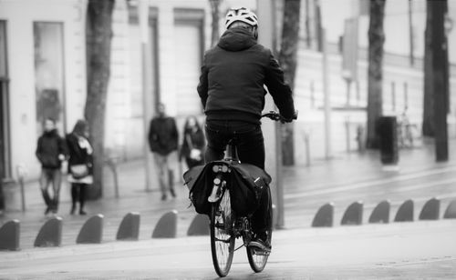 Man riding bicycle on city street