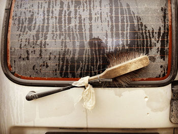 Close-up of old glass hanging on rope