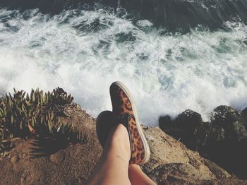 People on rocks at sea shore