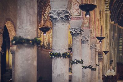 Wreaths decorated around columns in church