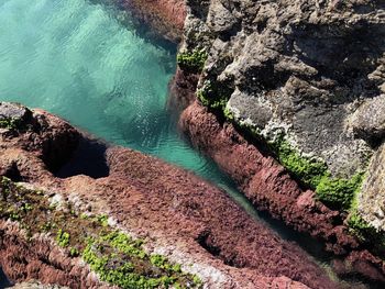 High angle view of rocks by sea