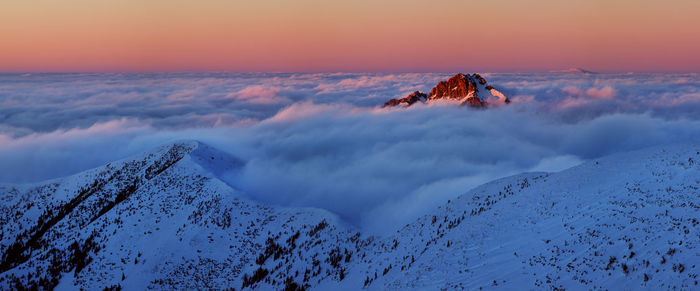 Scenic view of snowcapped mountains against sky during sunset
