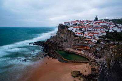 Panoramic view of sea and buildings against sky