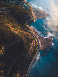 Aerial view of winding road by sea