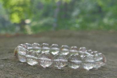 Close-up of beads bracelet on dirt